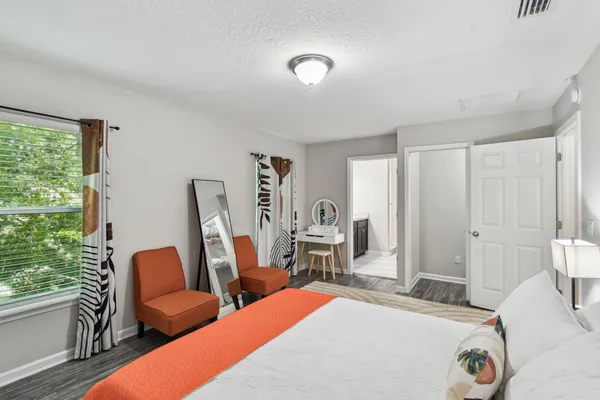 a bedroom with furniture and a window