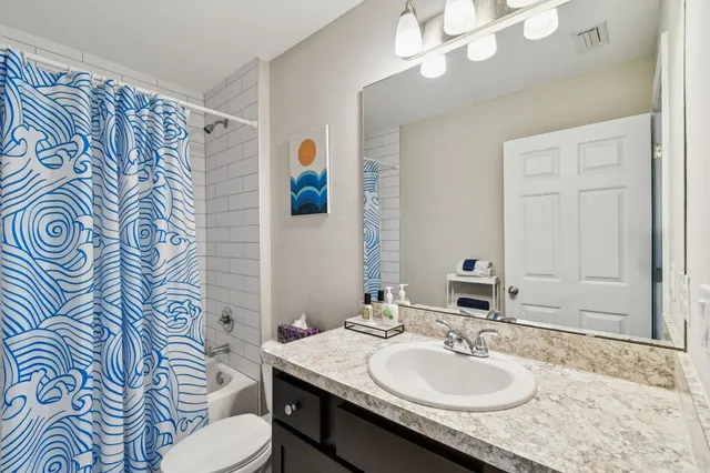 a bathroom with a sink a toilet and mirror