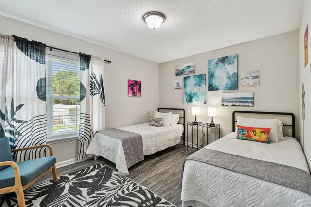 a bedroom with two beds and a couch