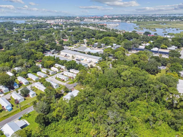 an aerial view of a house with a yard and lake view