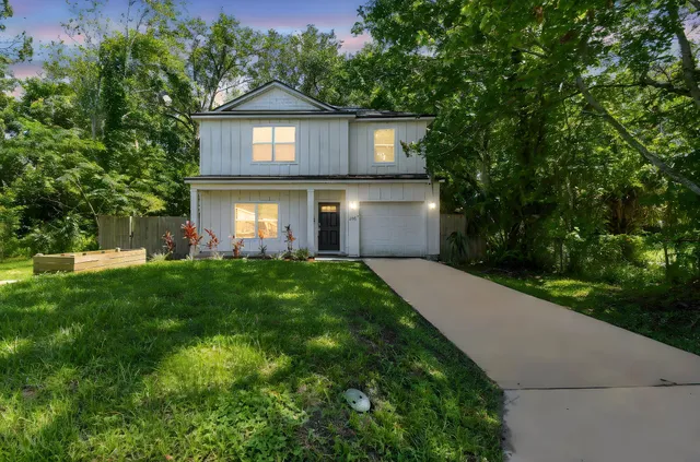 a front view of a house with a yard and garage
