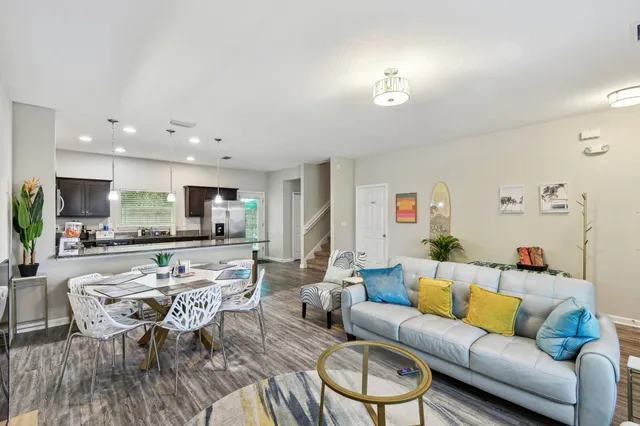 a living room with furniture wooden floor and a view of kitchen