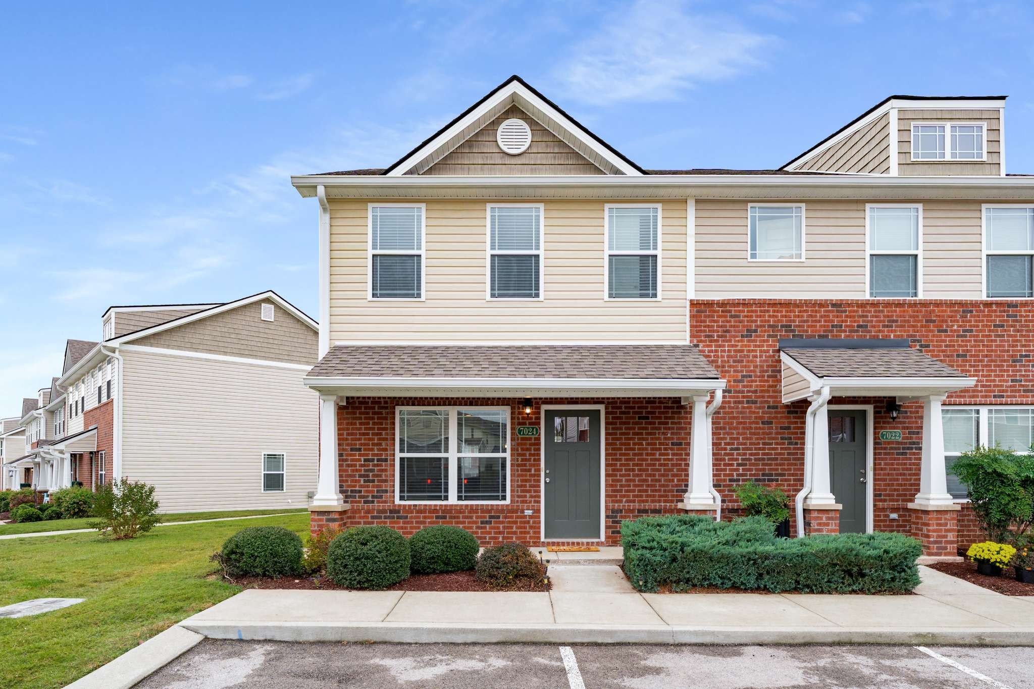 7024 Magnolia Crossings Spring Hill, TN 37174 - Photo 1 of 40 a front view of a house with a yard and garage