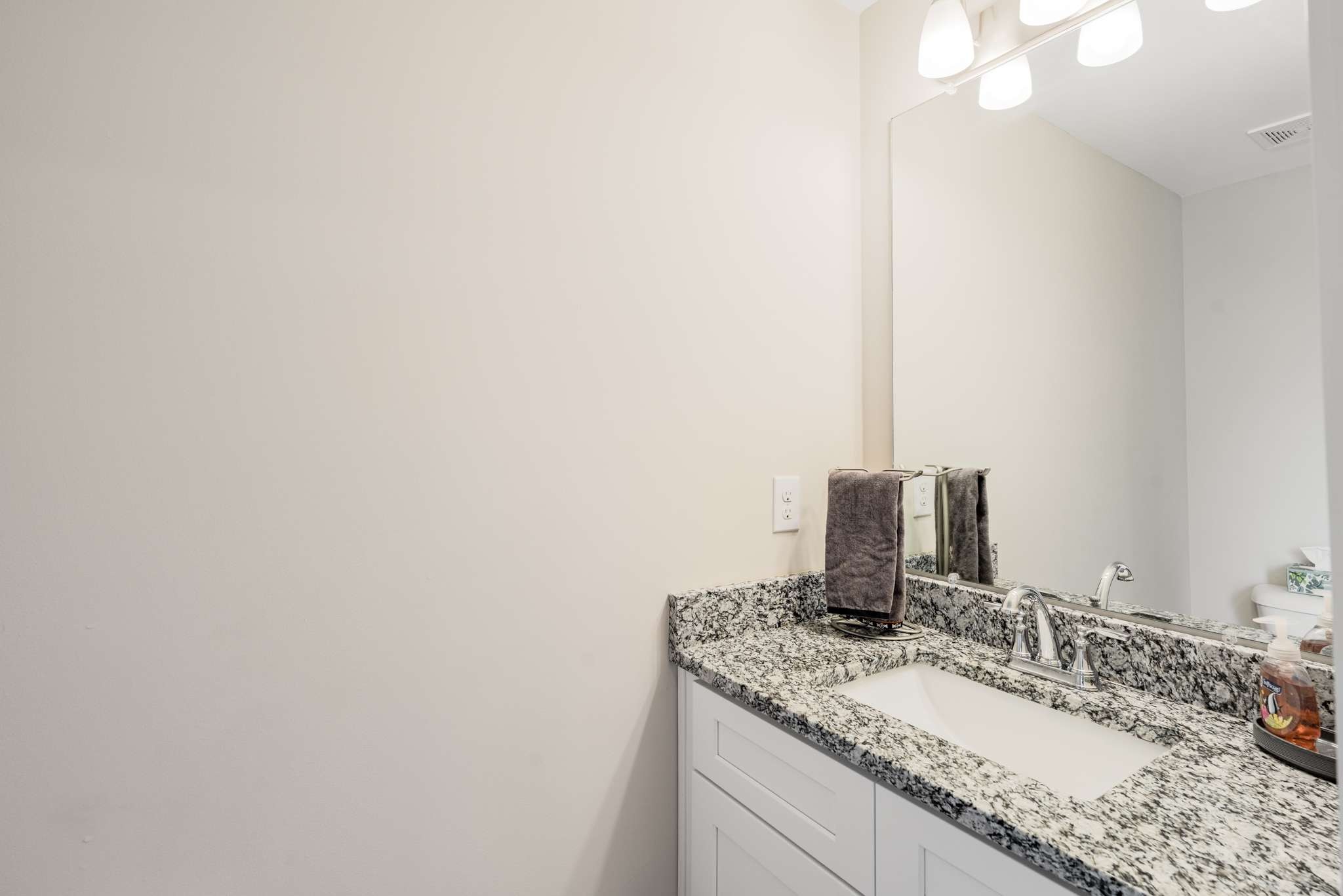 7024 Magnolia Crossings Spring Hill, TN 37174 - Photo 16 of 40 a bathroom with a granite countertop sink and a mirror