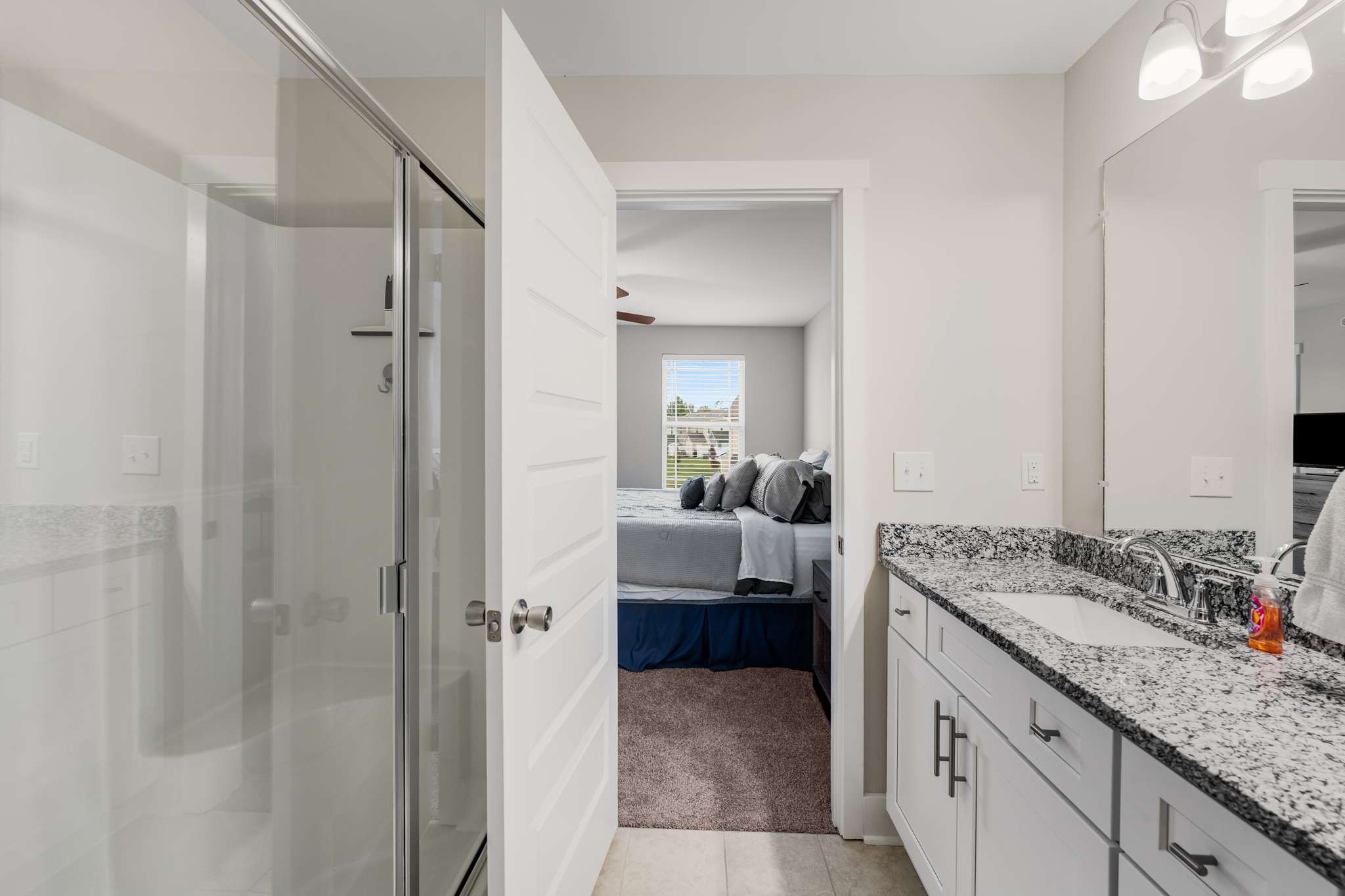 7024 Magnolia Crossings Spring Hill, TN 37174 - Photo 19 of 40 a en suite bathroom with a granite countertop sink and mirror