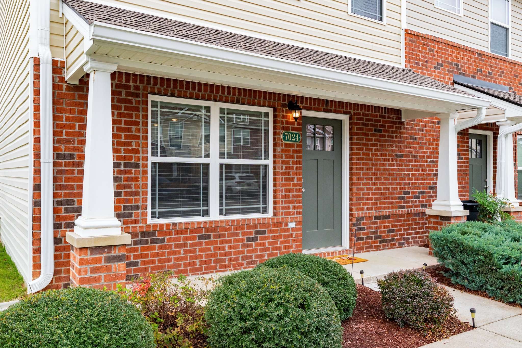 7024 Magnolia Crossings Spring Hill, TN 37174 - Photo 4 of 40 a front view of a brick house with a large windows