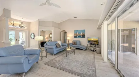 a living room with furniture wooden floor and a table