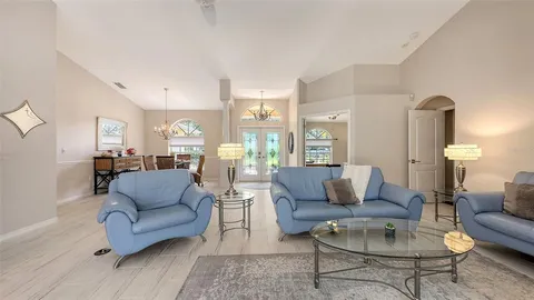 a living room with furniture and a large window