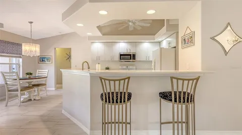 a dining room with furniture a chandelier and window