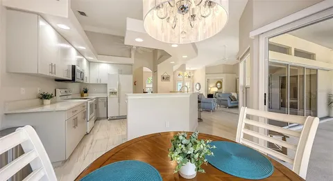 a kitchen with white cabinets stainless steel appliances and sink