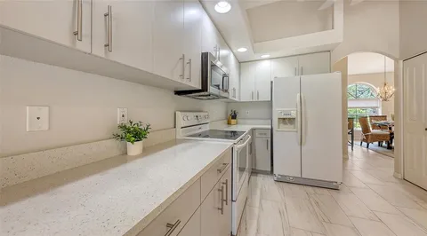 a dining room with furniture a chandelier and a rug