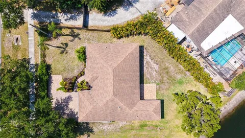 an aerial view of a house with a yard and garden