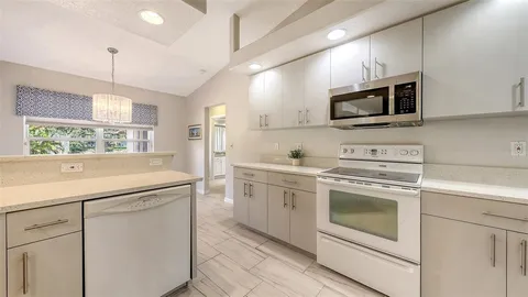 a view of a dining room with furniture a chandelier and wooden floor