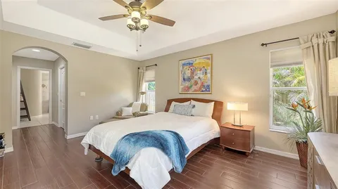 a bathroom with a granite countertop sink a mirror a bathtub and shower
