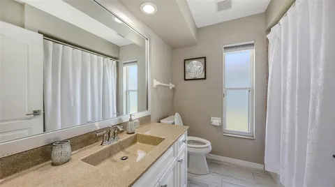 an aerial view of a house with a yard basket ball court and outdoor seating