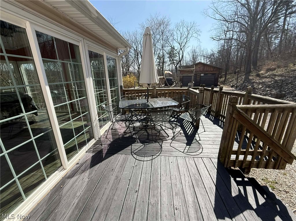 7170 Old Town Road Mount Perry, OH 43760 - Photo 32 of 41 Wooden terrace featuring outdoor dining area and a detached garage