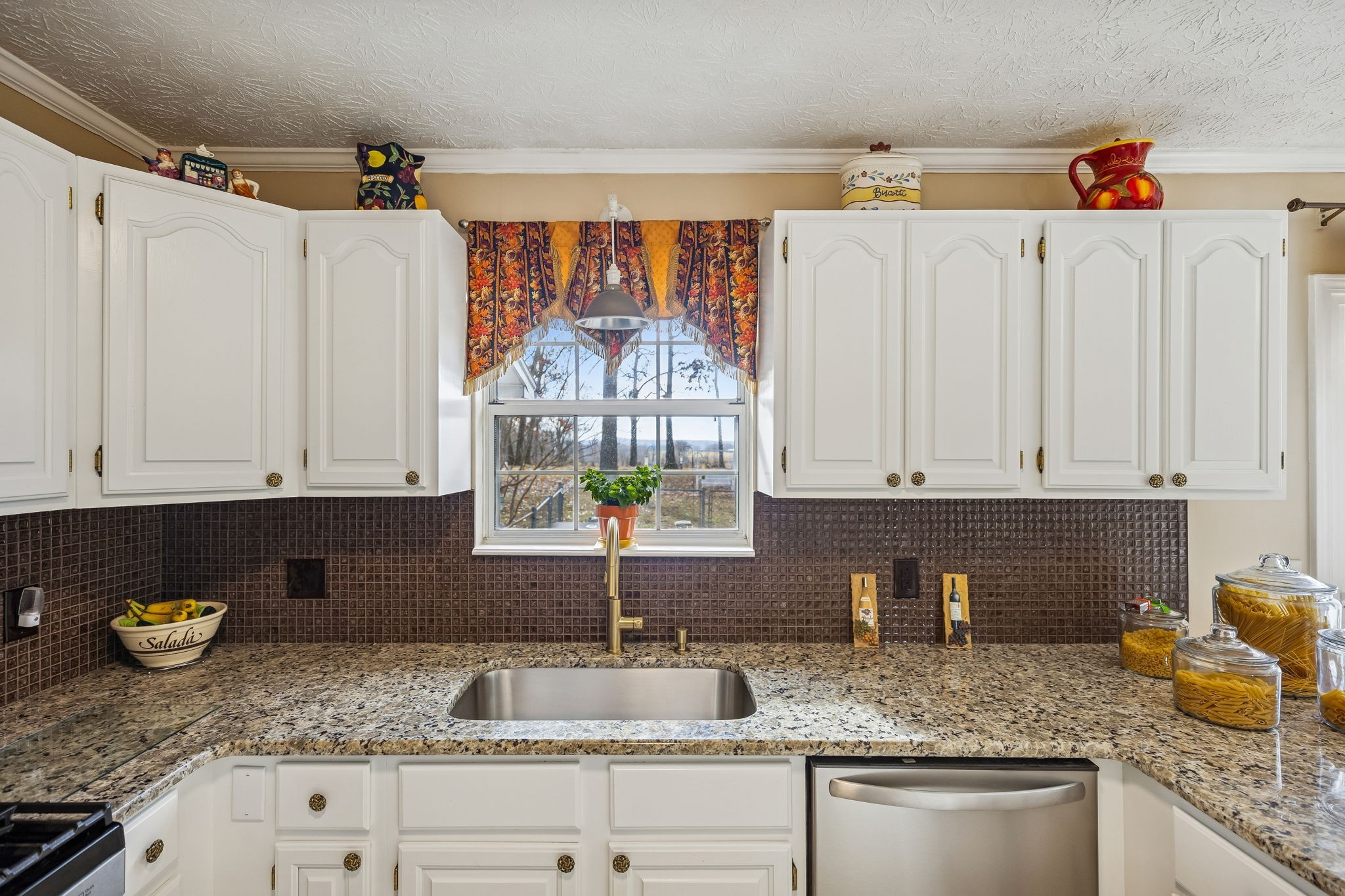 524 Willie Jarvis Road Sparta, TN 38583 - Photo 12 of 64 a kitchen with granite countertop white cabinets and sink
