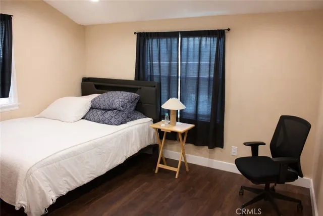 a bedroom with bed and a chair