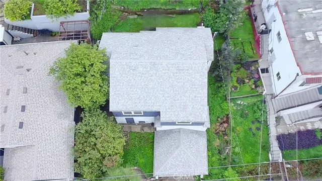 an aerial view of a house with outdoor space and street view