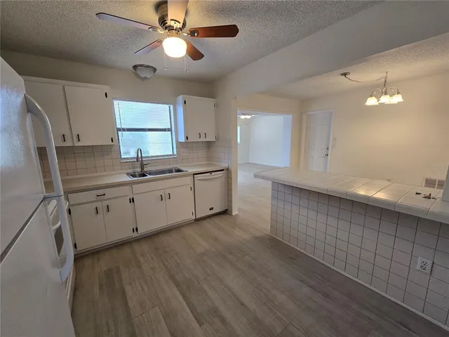a kitchen with a sink cabinets and window