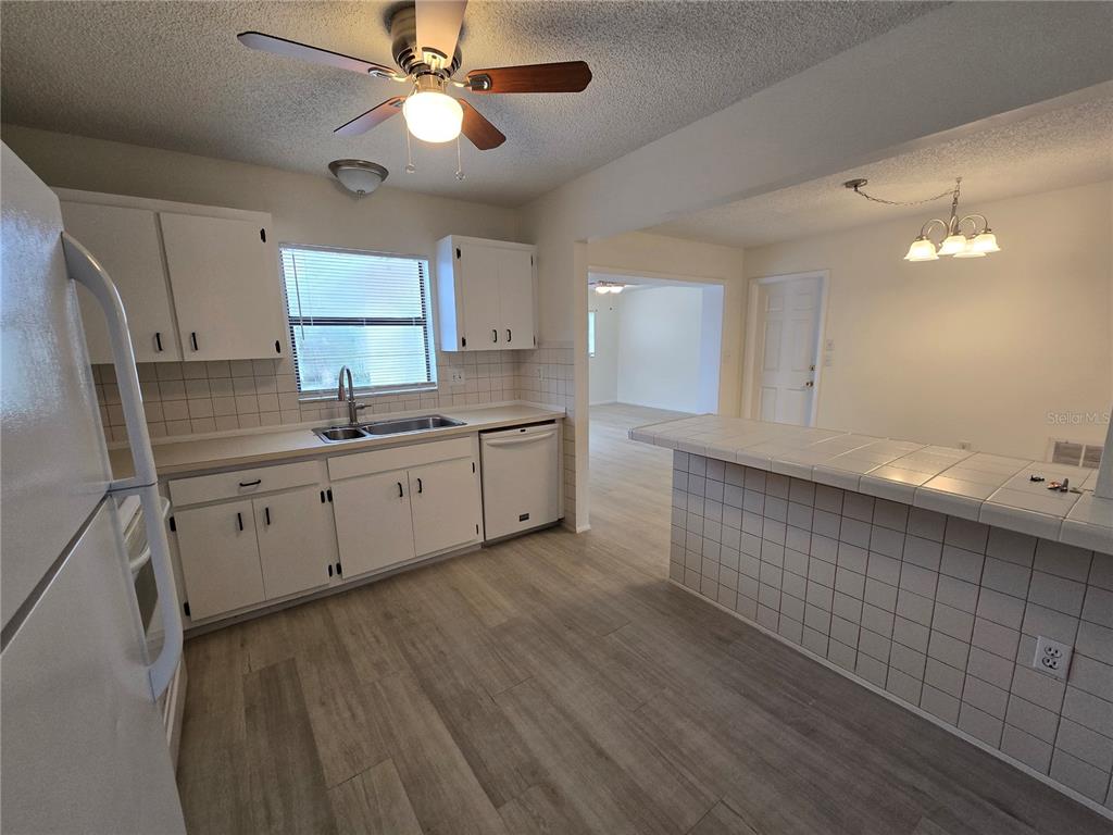 11127 Peppertree Lane Port Richey, FL 34668 - Photo 11 of 25 a kitchen with a sink cabinets and window