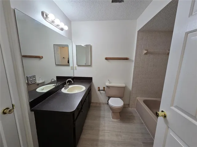 a bathroom with a sink toilet and a mirror
