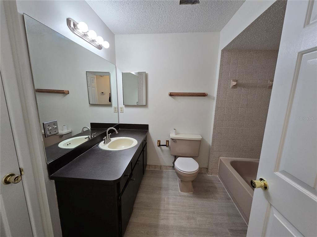 11127 Peppertree Lane Port Richey, FL 34668 - Photo 18 of 25 a bathroom with a sink toilet and a mirror