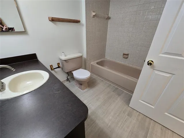 a bathroom with a sink a toilet and a bathtub