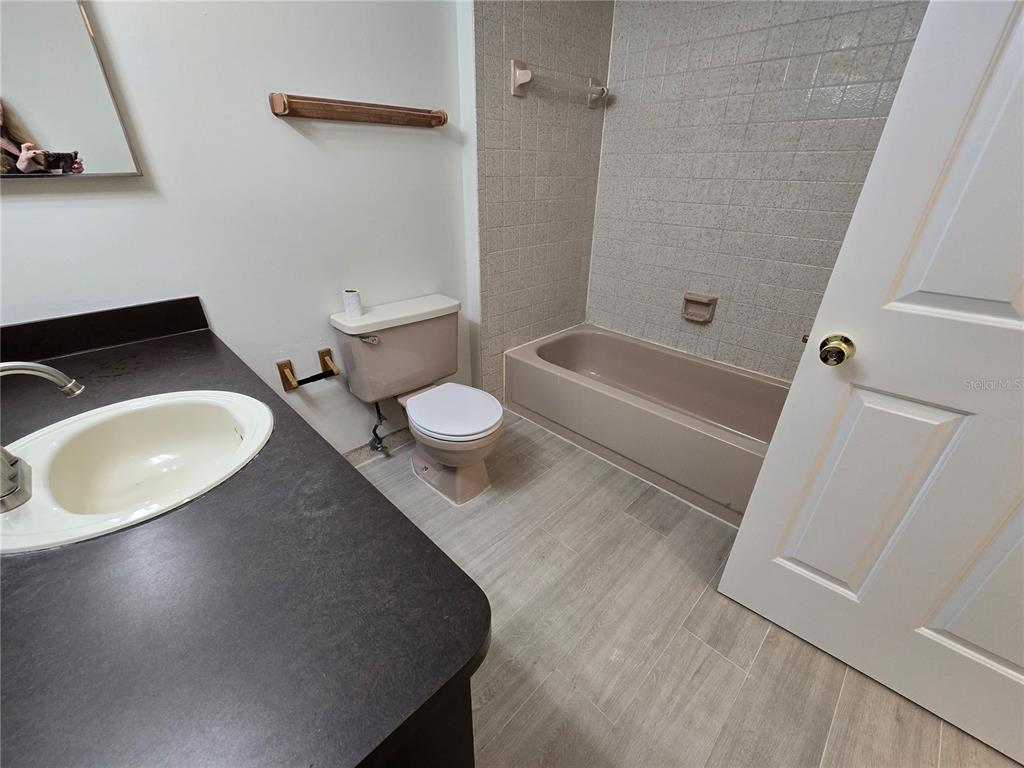 11127 Peppertree Lane Port Richey, FL 34668 - Photo 19 of 25 a bathroom with a sink a toilet and a bathtub