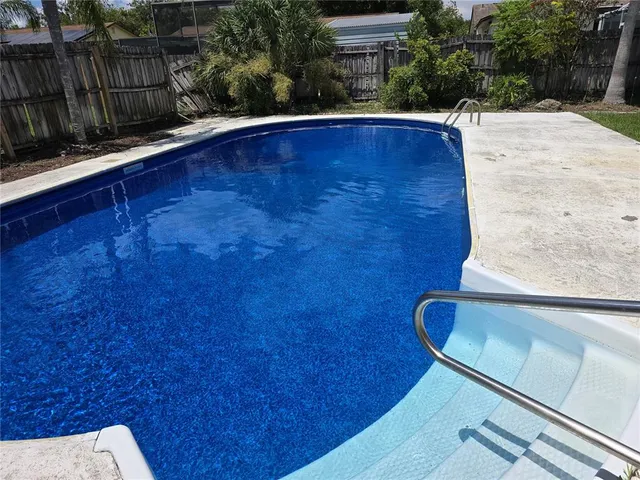 a view of outdoor space with swimming pool and patio