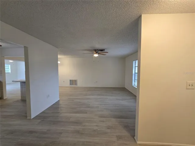 a view of a hallway with wooden floor