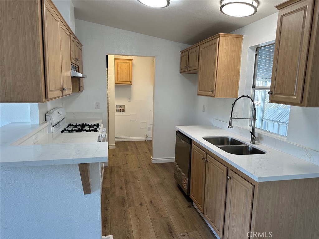 9861 Mission, Unit 14 Riverside, CA 92509 - Photo 11 of 23 a kitchen with a sink cabinets and wooden floor