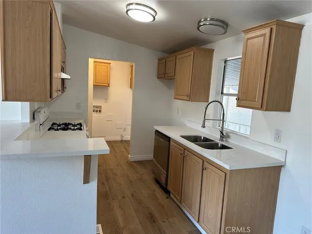 a kitchen with a sink a stove and cabinets