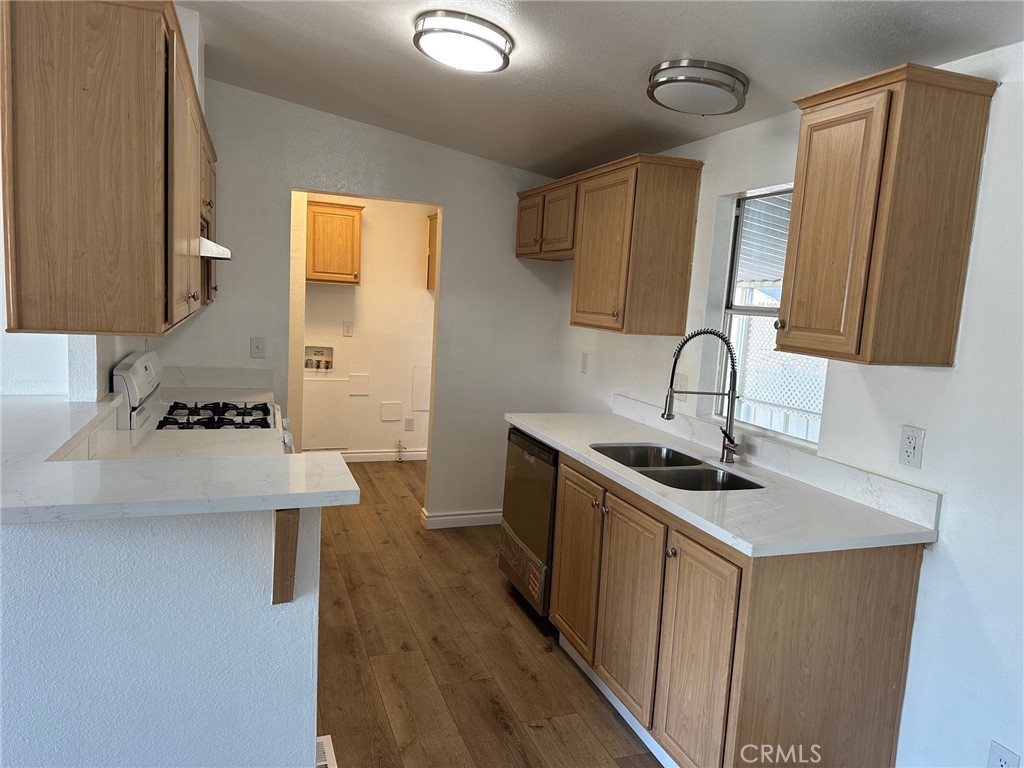 9861 Mission, Unit 14 Riverside, CA 92509 - Photo 12 of 23 a kitchen with a sink a stove and cabinets