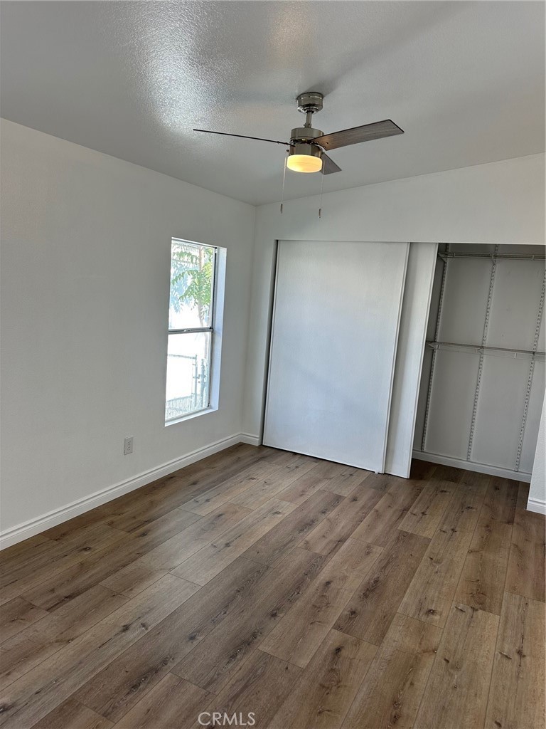9861 Mission, Unit 14 Riverside, CA 92509 - Photo 15 of 23 an empty room with wooden floor fan and windows