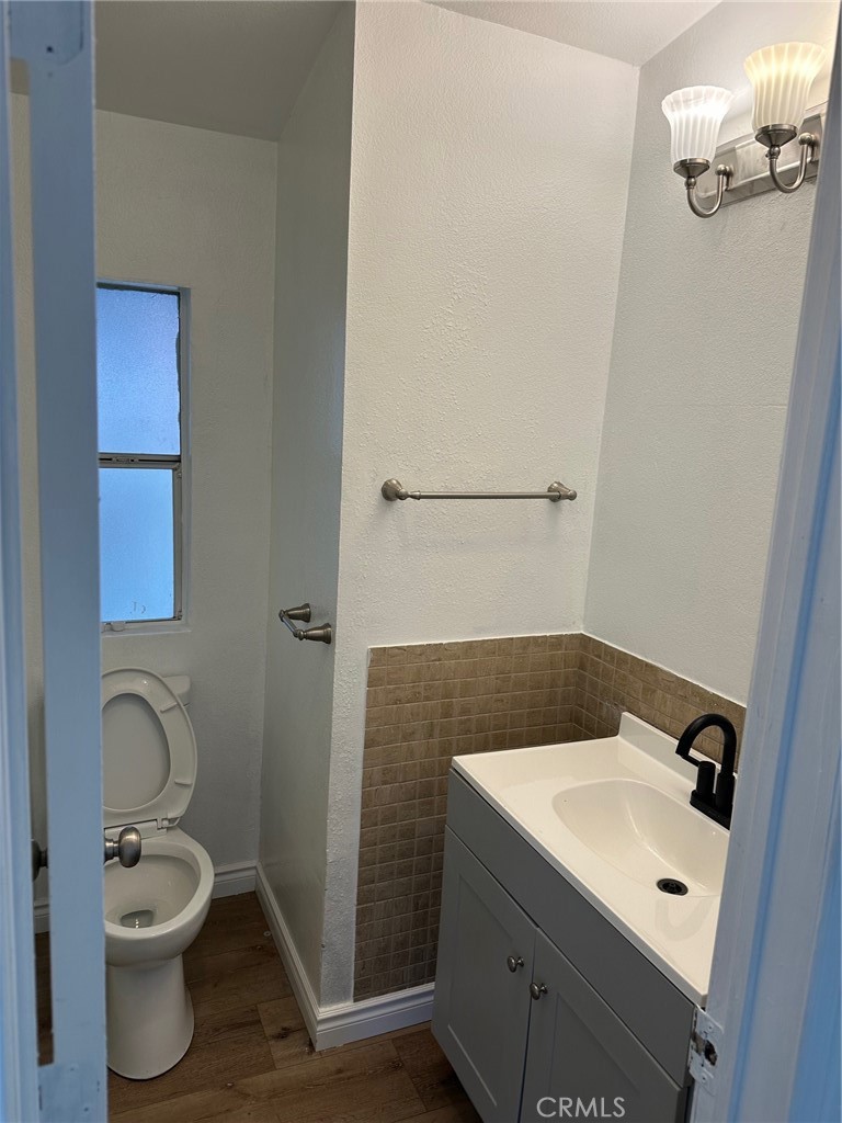 9861 Mission, Unit 14 Riverside, CA 92509 - Photo 16 of 23 a bathroom with a toilet sink and mirror