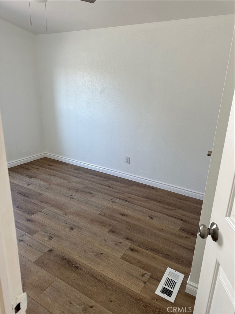 9861 Mission, Unit 14 Riverside, CA 92509 - Photo 17 of 23 an empty room with wooden floor and windows