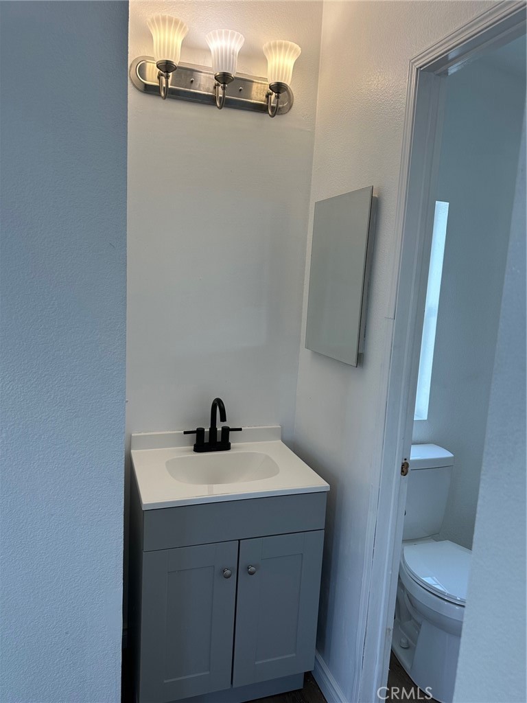 9861 Mission, Unit 14 Riverside, CA 92509 - Photo 20 of 23 a bathroom with a sink a toilet and mirror
