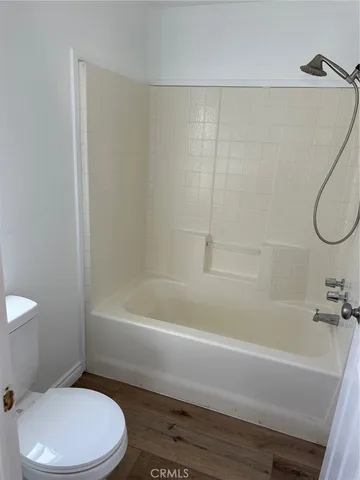 a bathroom with a toilet and a bathtub