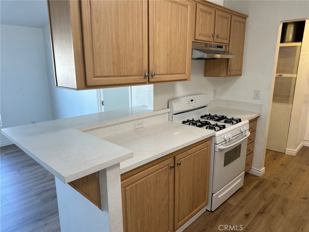 9861 Mission, Unit 14 Riverside, CA 92509 - Photo 9 of 23 a kitchen with stainless steel appliances a stove a microwave and cabinets
