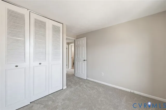 an empty room with a window and a ceiling fan