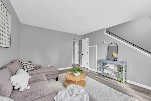 a living room with furniture and a potted plant