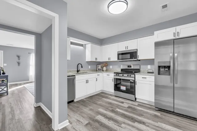 a kitchen with a refrigerator stove and sink