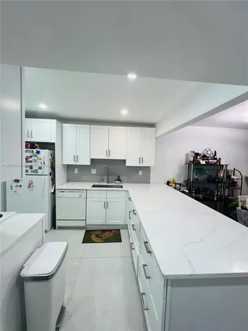 a kitchen with a sink a stove and cabinets