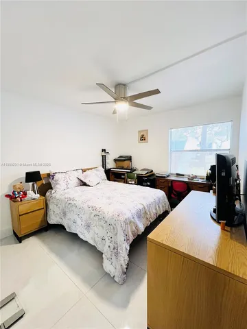 a bedroom with bed and window