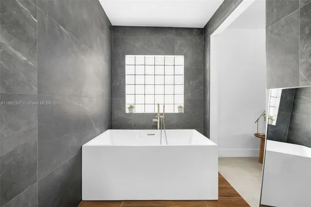 a white bath tub sitting in a bathroom