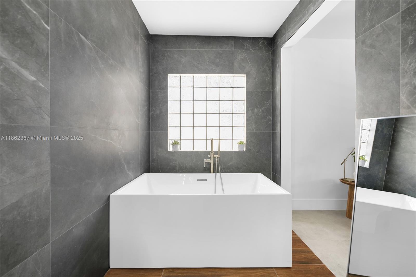 620 Southwest 22nd Road Miami, FL 33129 - Photo 11 of 31 a white bath tub sitting in a bathroom