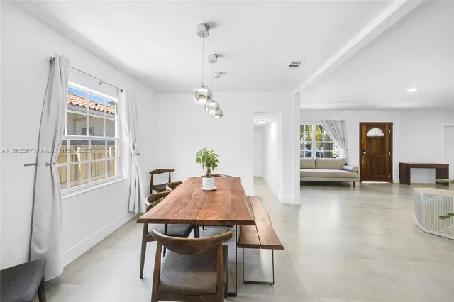 a view of a dining room with furniture and window