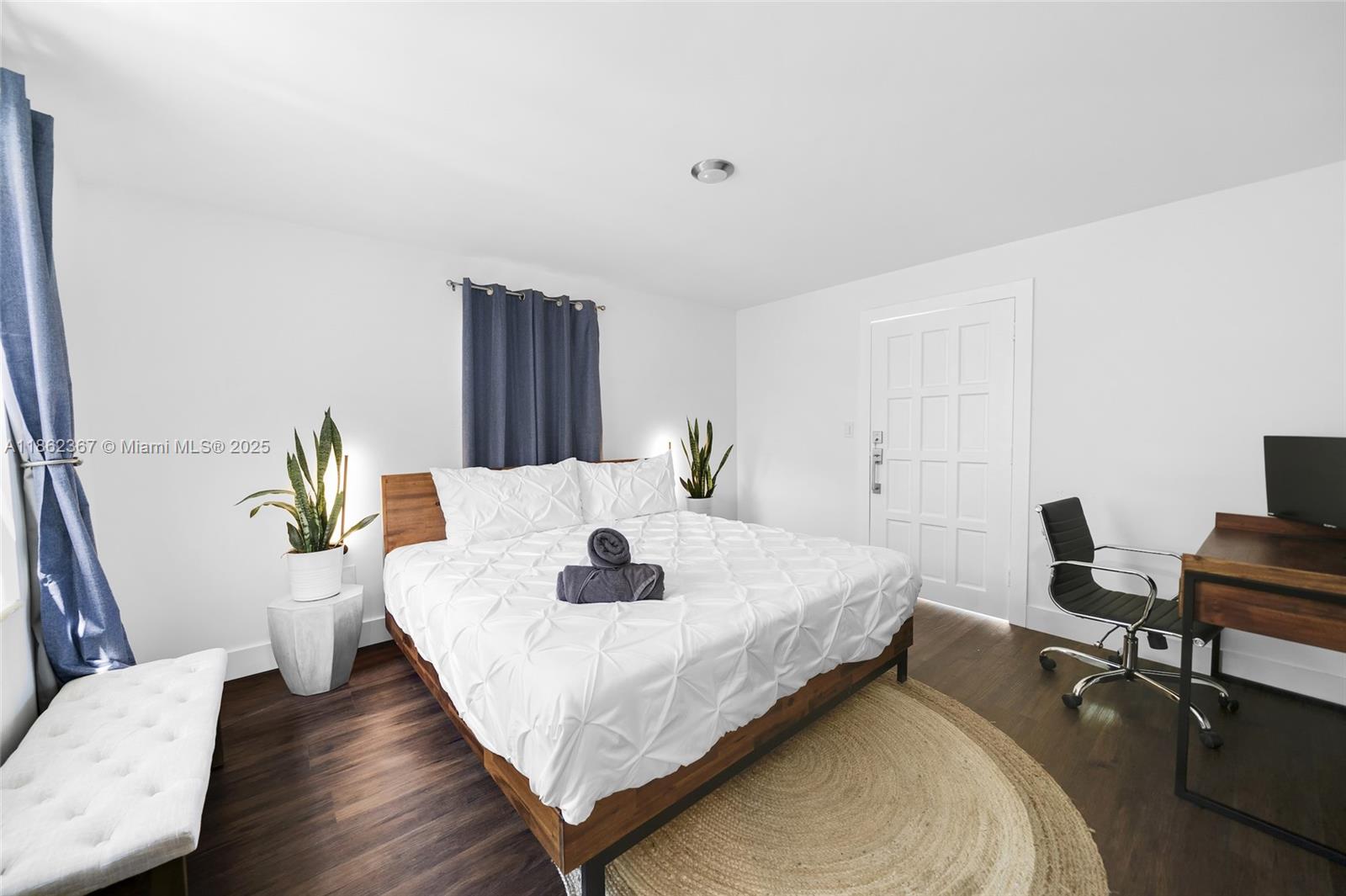 620 Southwest 22nd Road Miami, FL 33129 - Photo 15 of 31 a bedroom with a bed and a table