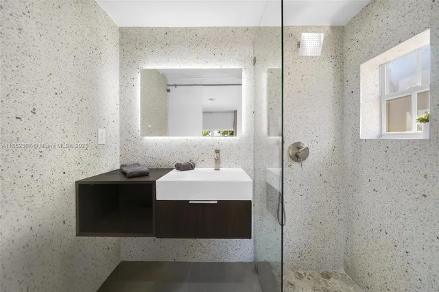 a bathroom with a sink and a mirror